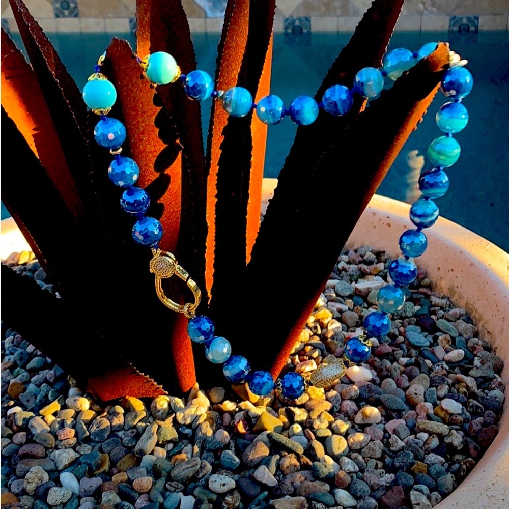22” lapis baroque pearls highlighted with gold colored sparkly accents